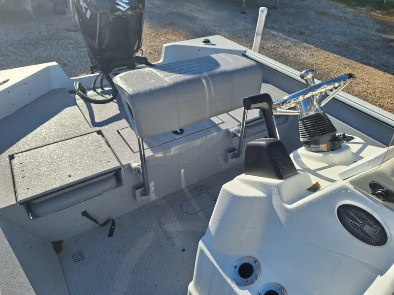 Slide: The Image of 2024 SeaArk 210 Bayrunner boat interior with steering console and seating. - 4