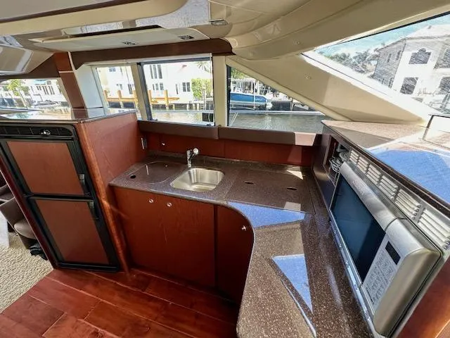 Slide: The Image of 2013 Meridian 441 Sedan yacht kitchen with modern appliances and waterfront view. - 14