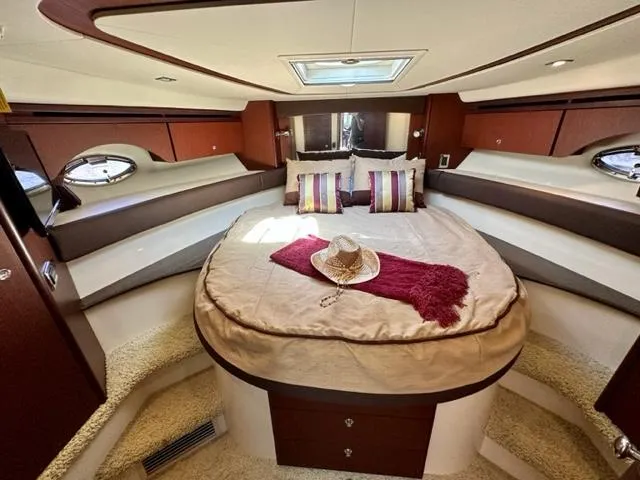 Slide: The Image of Luxurious 2013 Meridian 441 Sedan yacht bedroom with cozy bed and stylish decor. - 19