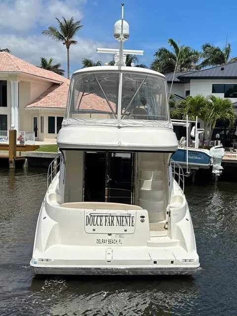 Slide: The Image of 2013 Meridian 441 Sedan yacht docked in a sunny marina. - 2