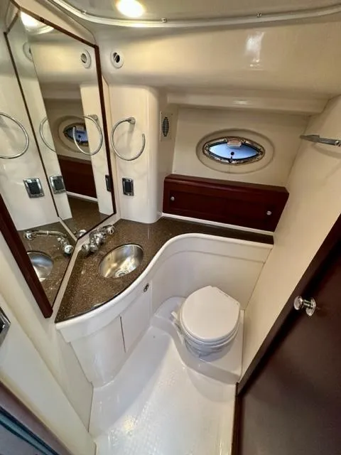 Slide: The Image of 2013 Meridian 441 Sedan yacht bathroom with modern fixtures and porthole window. - 22