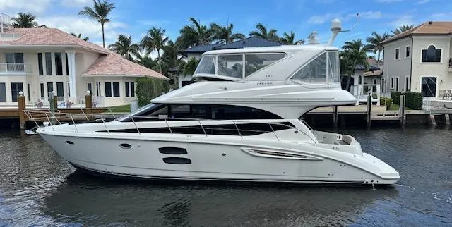 Slide: The Image of 2013 Meridian 441 Sedan yacht docked near waterfront homes. - 4