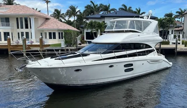 Slide: The Image of 2013 Meridian 441 Sedan yacht docked near waterfront homes. - 5