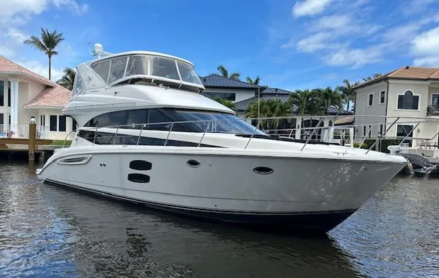 Slide: The Image of 2013 Meridian 441 Sedan yacht docked near waterfront homes. - 6