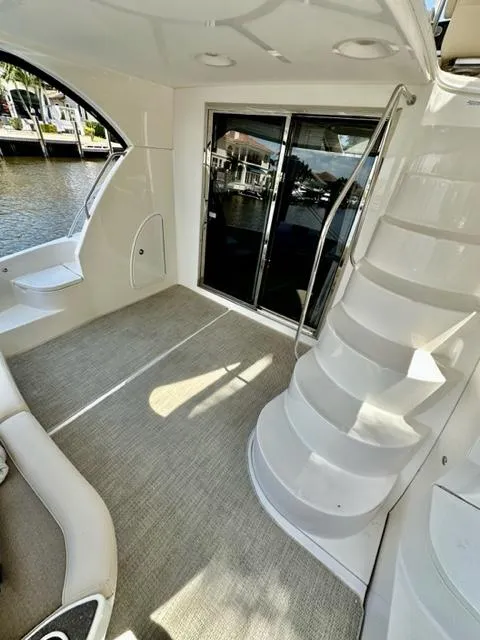 Slide: The Image of 2013 Meridian 441 Sedan yacht interior with stairs and waterfront view. - 8