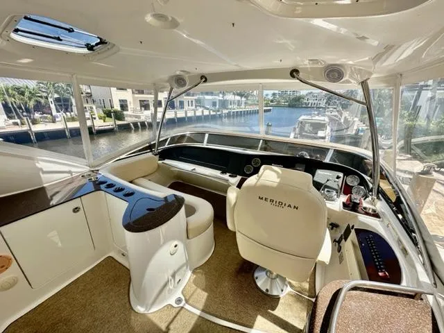 Slide: The Image of Interior of a 2013 Meridian 441 Sedan yacht with helm station and waterfront view. - 9