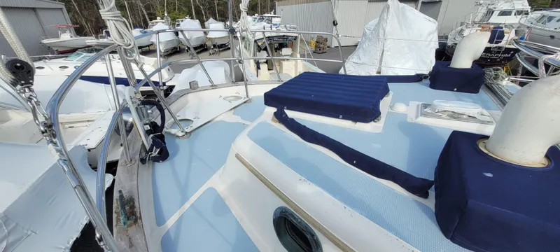 Slide: The Image of 1976 Westsail Ketch sailboat deck with blue cushions and nautical equipment. - 20