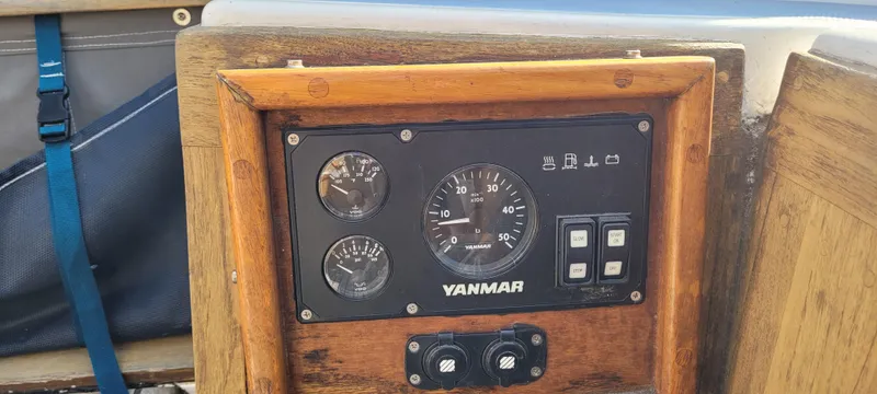Slide: The Image of 1976 Westsail Ketch Yanmar engine control panel with gauges and switches. - 21