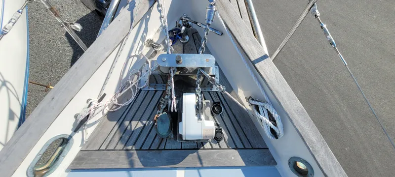 Slide: The Image of 1976 Westsail Ketch bow with anchor and winch system, detailed deck view. - 24