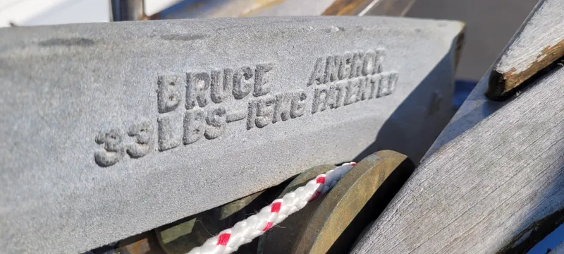 Slide: The Image of Close-up of a Bruce anchor on a 1976 Westsail Ketch, showing engraved weight and patent details. - 26