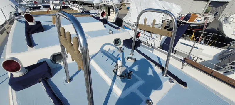 Slide: The Image of 1976 Westsail Ketch deck with stainless steel railings and nautical equipment. - 29