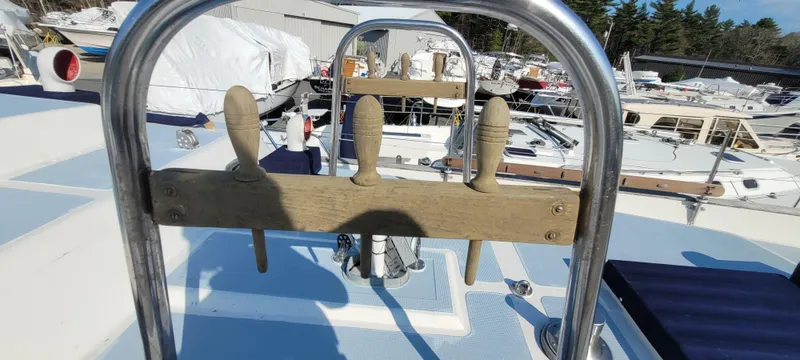 Slide: The Image of 1976 Westsail Ketch deck with wooden handles and marina background. - 30