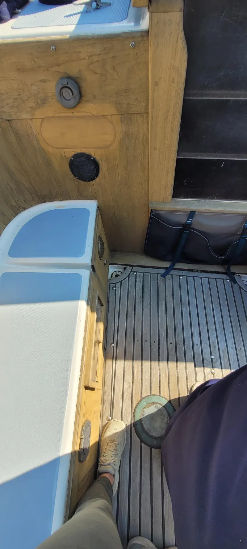 Slide: The Image of 1976 Westsail Ketch deck with wooden flooring and seating area. - 36