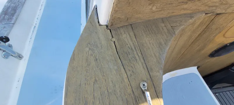 Slide: The Image of 1976 Westsail Ketch deck with wood finish and hardware details. - 38