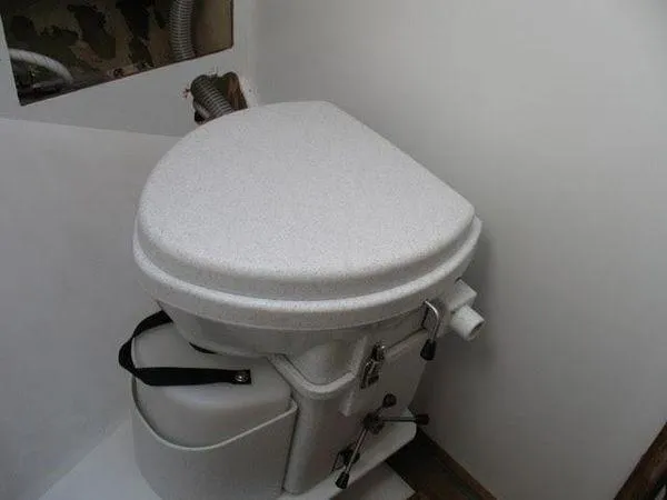 Slide: The Image of 1976 Westsail Ketch marine toilet in compact bathroom setting. - 8