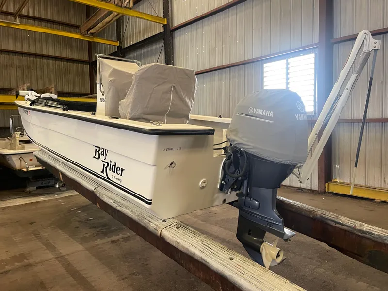 Slide: The Image of 2013 KenCraft Bay Rider 1860 boat with Yamaha outboard motor in storage facility. - 11