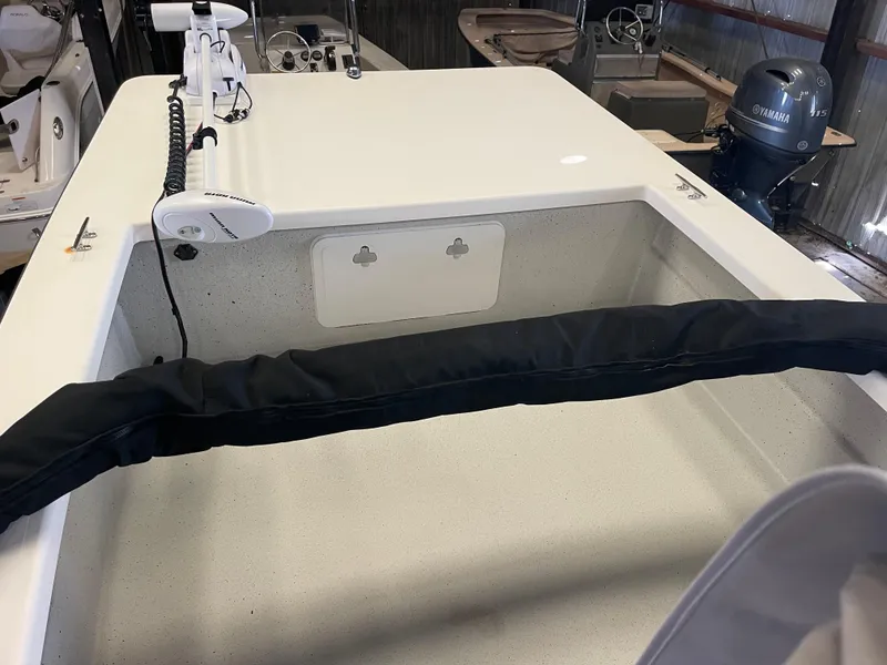 Slide: The Image of 2013 KenCraft Bay Rider 1860 boat interior with motor and equipment in storage. - 16