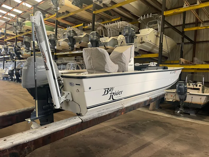 Slide: The Image of 2013 KenCraft Bay Rider 1860 boat in storage, surrounded by other vessels. - 6