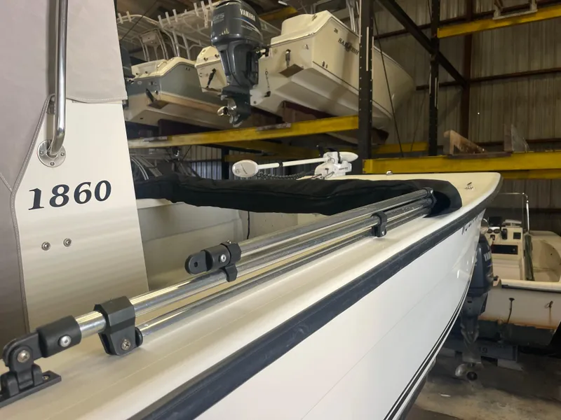 Slide: The Image of 2013 KenCraft Bay Rider 1860 boat in storage, showcasing side view and equipment. - 8