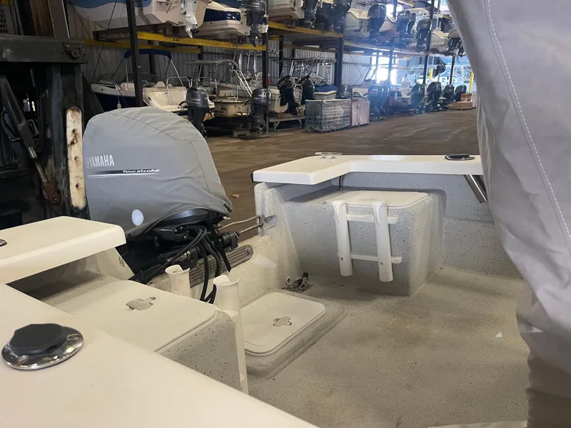 Slide: The Image of 2013 KenCraft Bay Rider 1860 boat interior with Yamaha outboard motor in storage facility. - 9