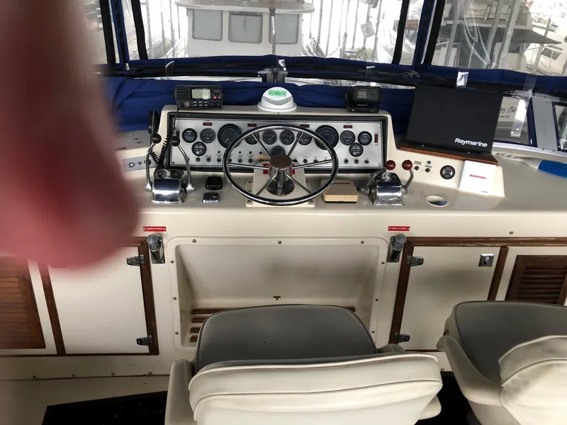 Slide: The Image of 1986 Chris-Craft Catalina boat cockpit with steering wheel and control panel. - 11