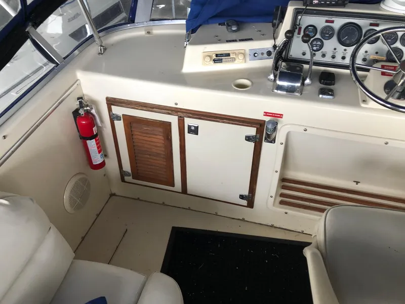 Slide: The Image of 1986 Chris-Craft Catalina boat interior with control panel and fire extinguisher. - 12