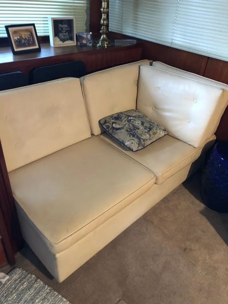Slide: The Image of Cream-colored sofa in the cabin of a 1986 Chris-Craft Catalina boat. - 15