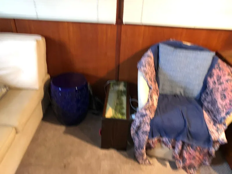 Slide: The Image of Interior of 1986 Chris-Craft Catalina with chair, side table, and sofa. - 16