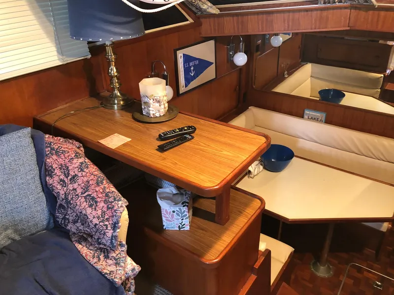 Slide: The Image of Interior of 1986 Chris-Craft Catalina boat with wooden table and seating area. - 17