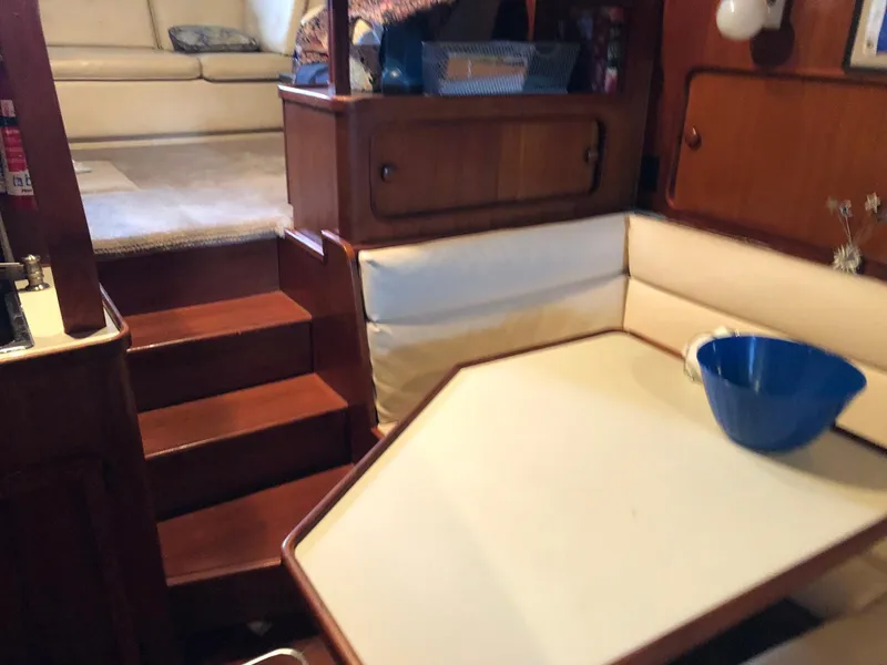 Slide: The Image of Interior of 1986 Chris-Craft Catalina boat with wooden stairs and seating area. - 25