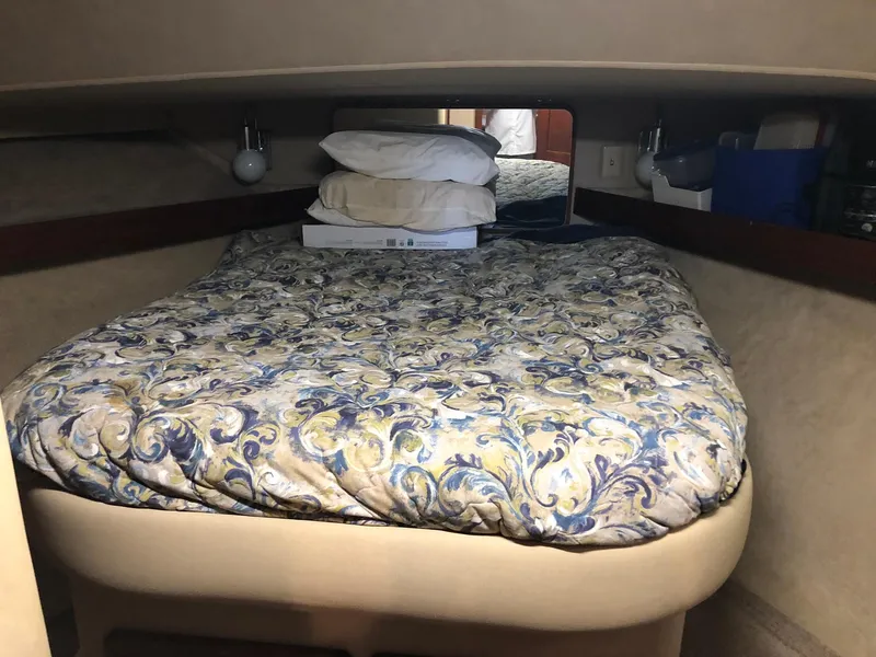 Slide: The Image of 1986 Chris-Craft Catalina cabin interior with bed and patterned bedding. - 26