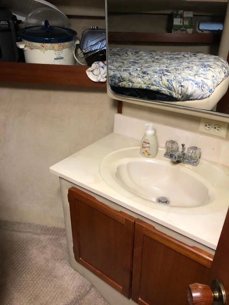 Slide: The Image of 1986 Chris-Craft Catalina boat interior with sink and sleeping area. - 28