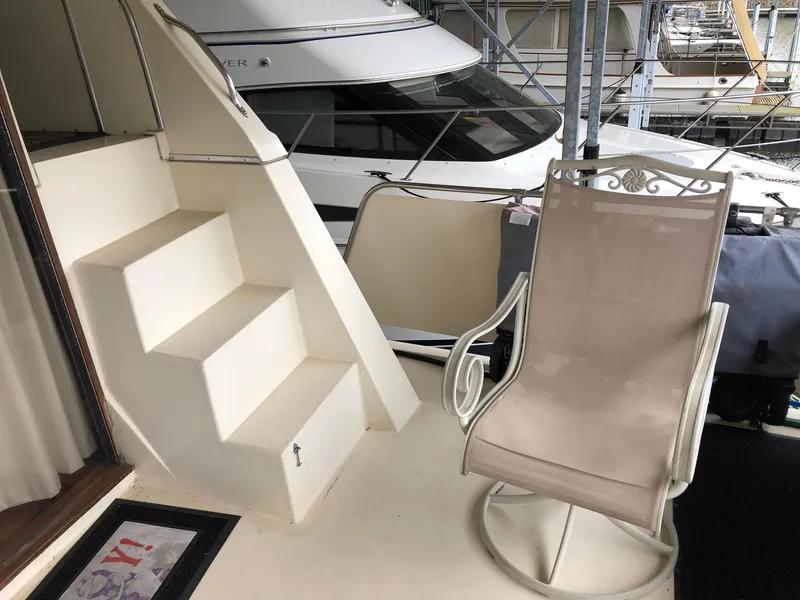 Slide: The Image of 1986 Chris-Craft Catalina boat interior with stairs and a swivel chair. - 3