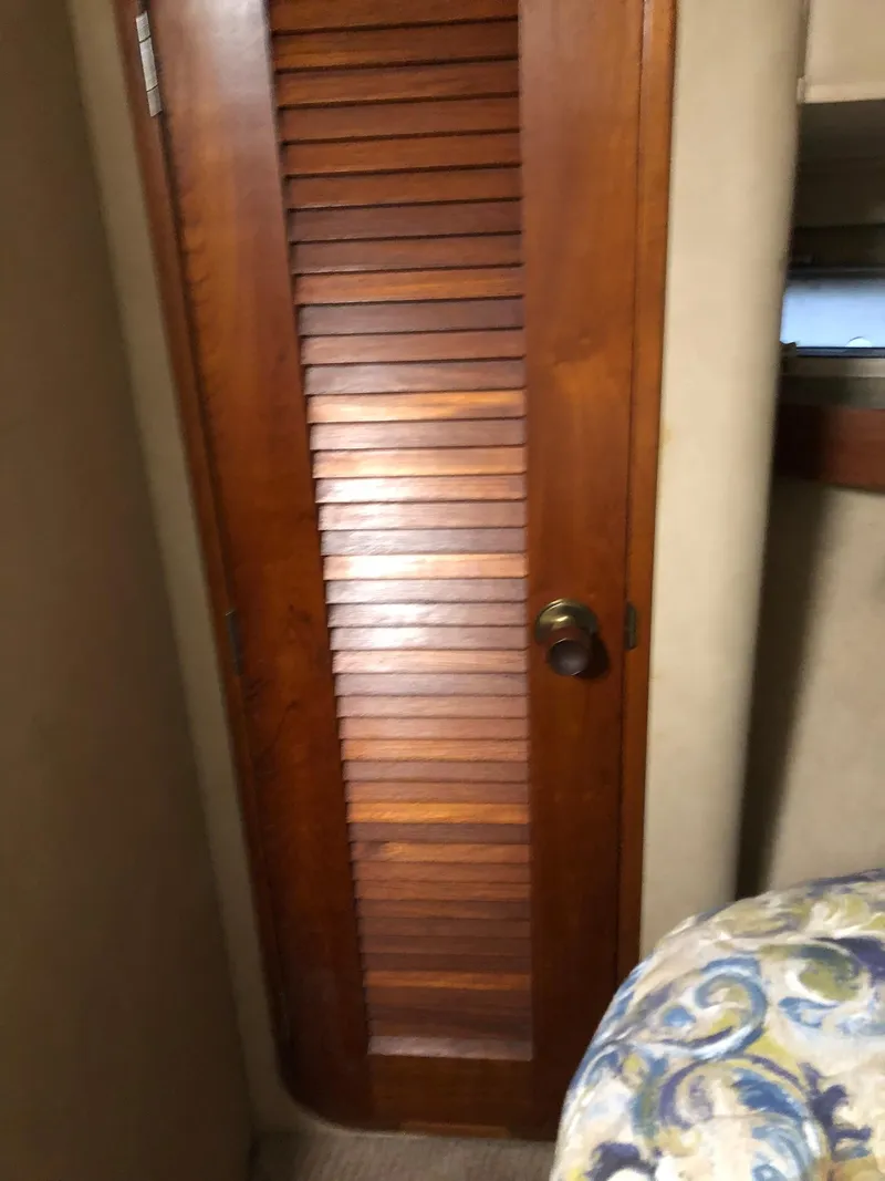 Slide: The Image of 1986 Chris-Craft Catalina interior wooden door with louvered design. - 30