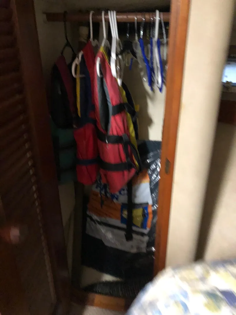 Slide: The Image of Closet with life jackets and hangers on a 1986 Chris-Craft Catalina boat. - 31