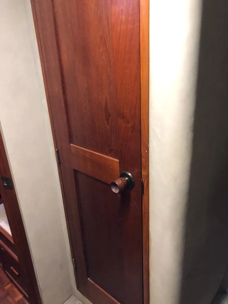 Slide: The Image of Wooden door inside 1986 Chris-Craft Catalina boat. - 32