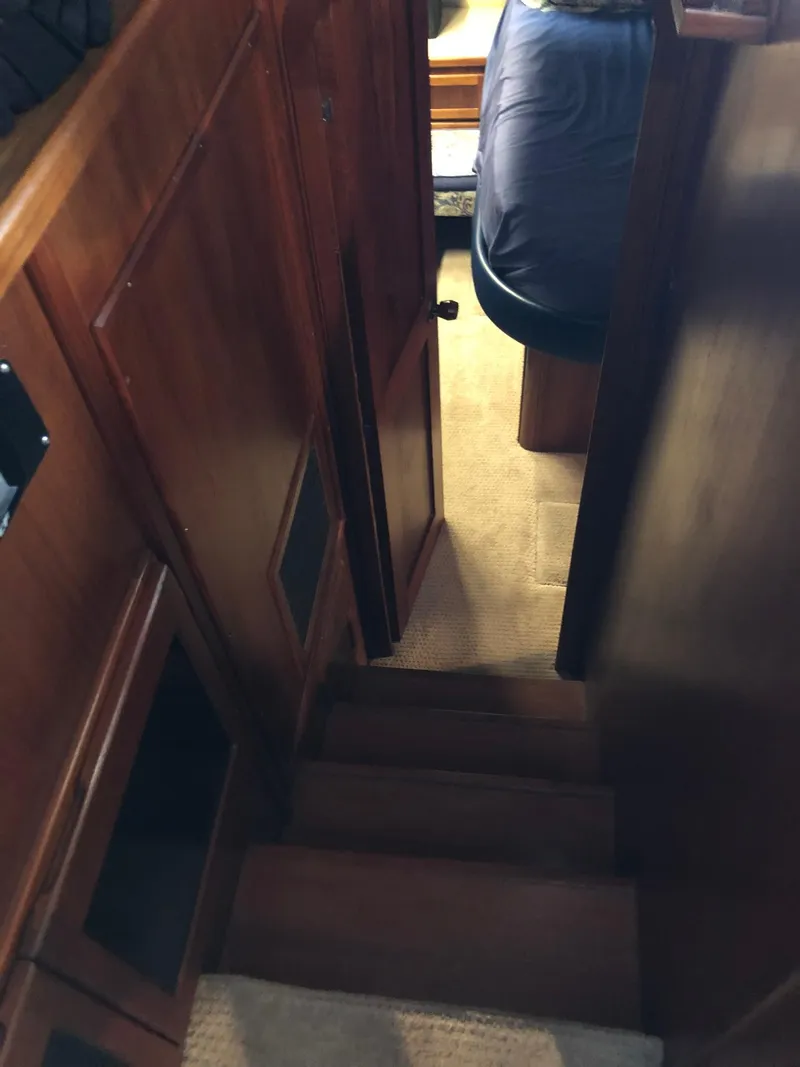Slide: The Image of 1986 Chris-Craft Catalina interior stairs with wooden finish and carpeted steps. - 34