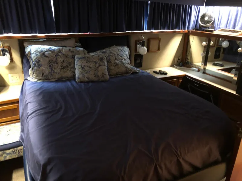 Slide: The Image of 1986 Chris-Craft Catalina bedroom with blue bedding and floral pillows. - 35