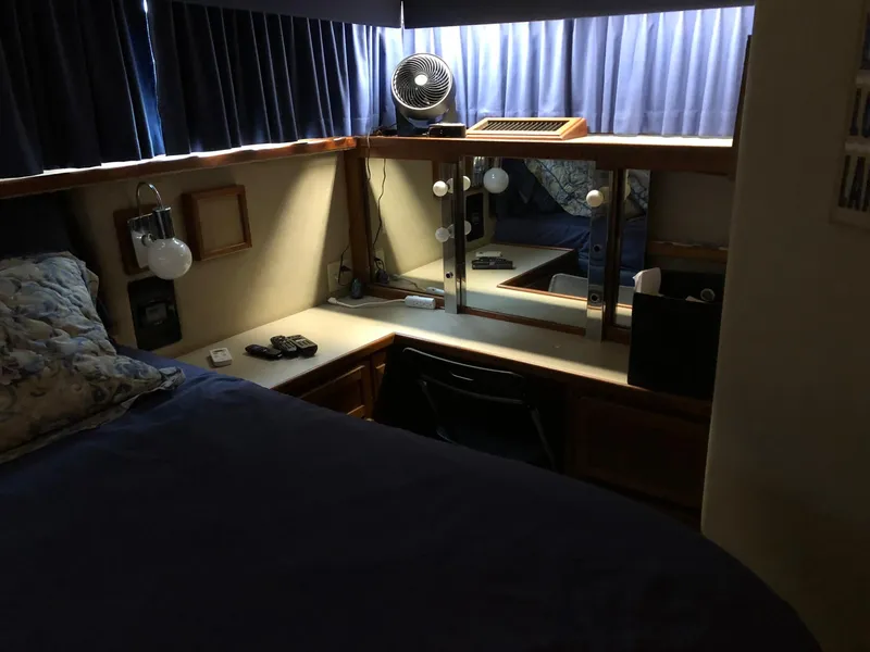 Slide: The Image of 1986 Chris-Craft Catalina cabin interior with bed, vanity, and fan. - 36