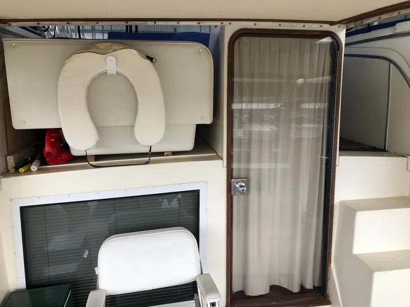 Slide: The Image of 1986 Chris-Craft Catalina boat interior with seating and storage compartments. - 4
