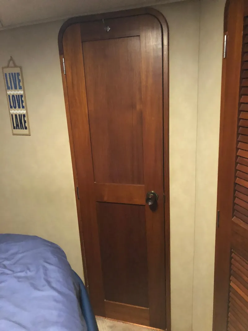 Slide: The Image of Wooden cabin door inside a 1986 Chris-Craft Catalina boat. - 40