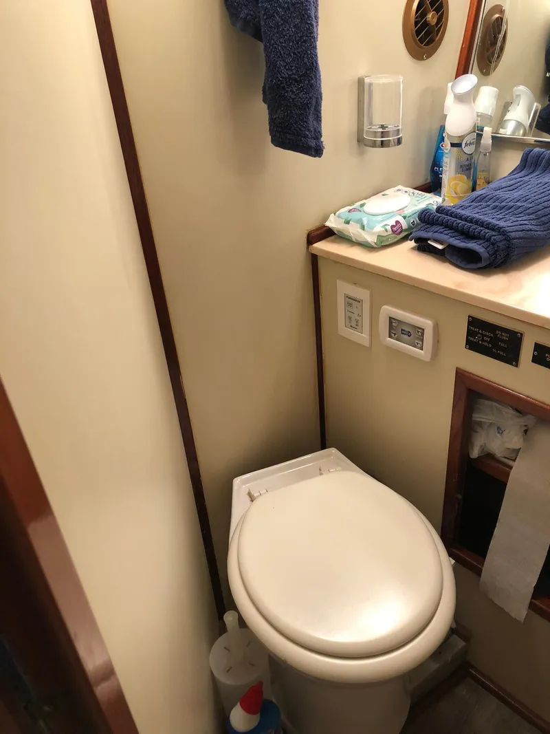 Slide: The Image of 1986 Chris-Craft Catalina boat bathroom with toilet, sink, and toiletries. - 42