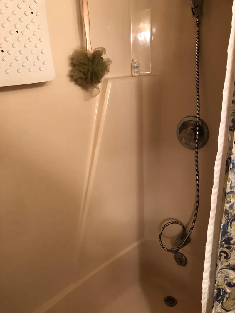 Slide: The Image of 1986 Chris-Craft Catalina boat shower with handheld showerhead and bath accessories. - 43