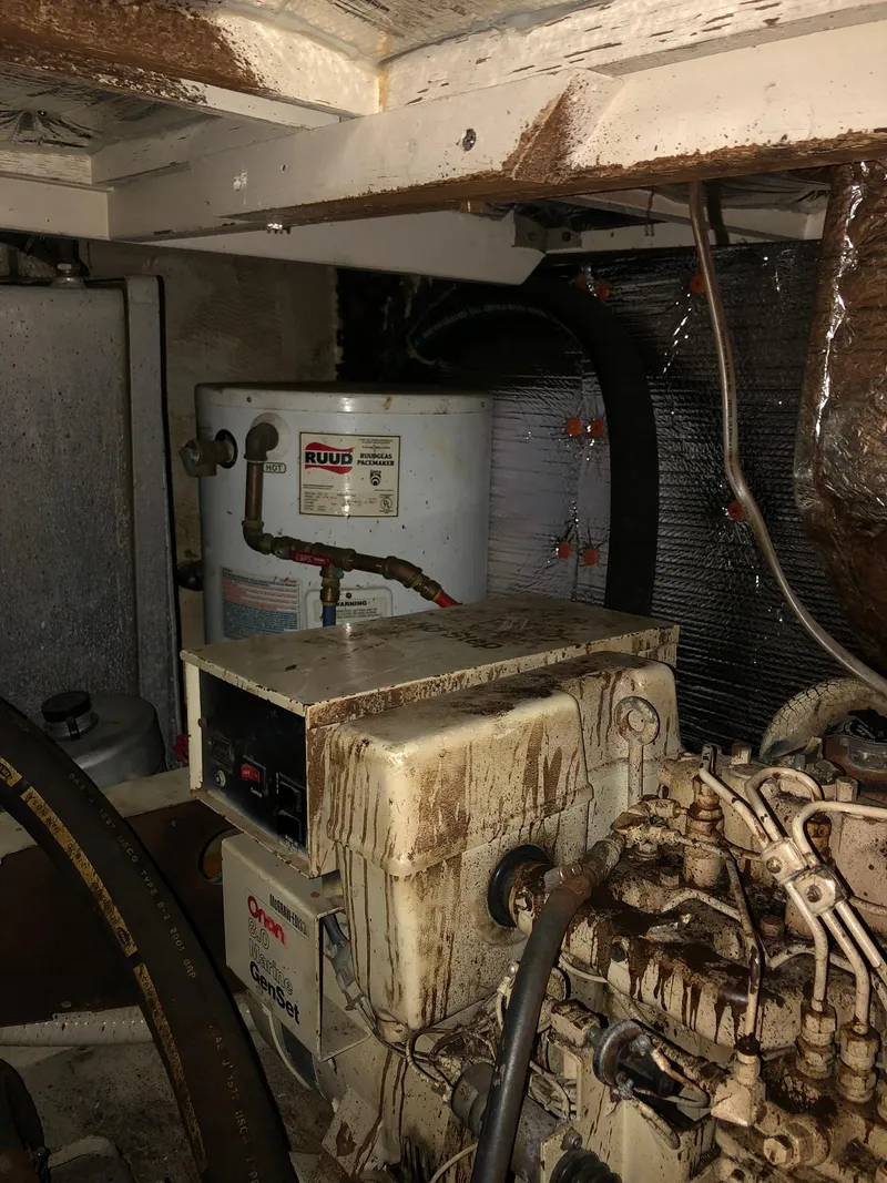Slide: The Image of 1986 Chris-Craft Catalina engine room with water heater and generator. - 48