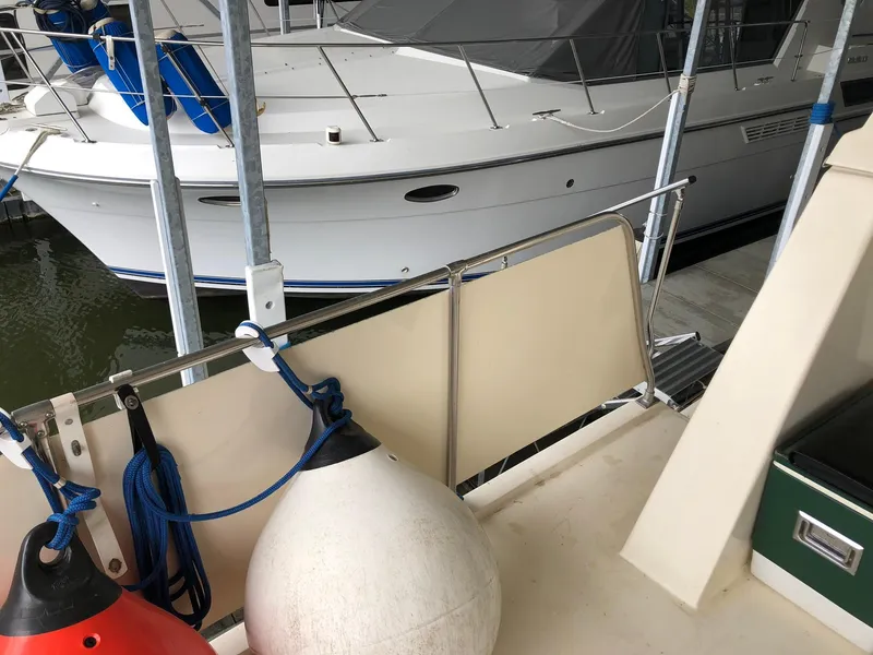 Slide: The Image of 1986 Chris-Craft Catalina boat docked with fenders and ropes. - 5