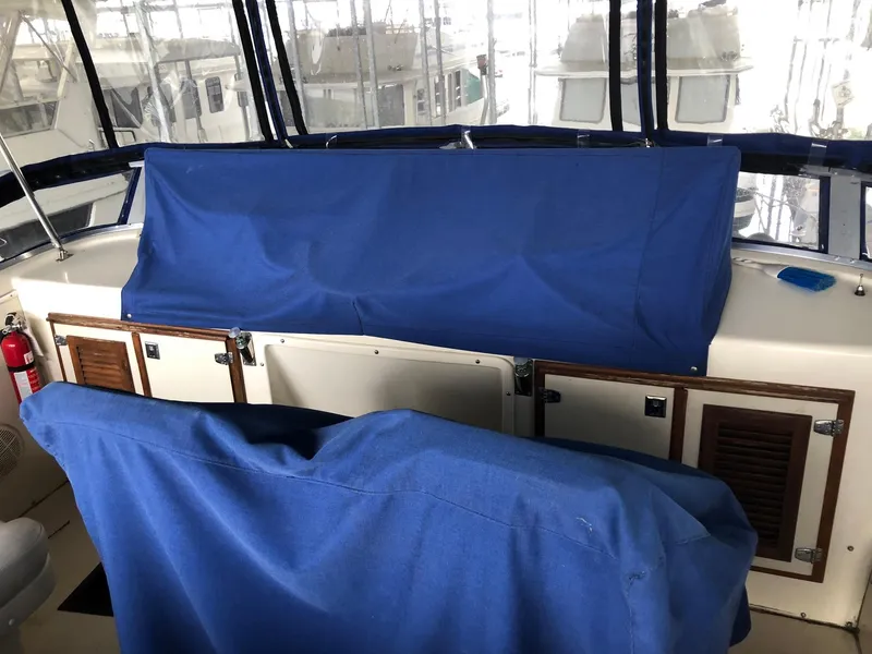 Slide: The Image of 1986 Chris-Craft Catalina boat interior with blue covered seats and control panel. - 8