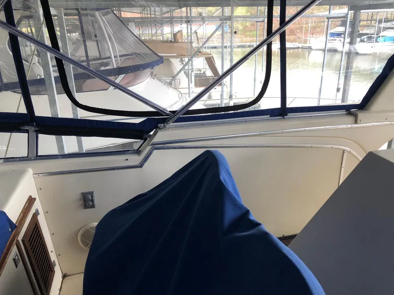 Slide: The Image of 1986 Chris-Craft Catalina boat interior with blue covers, docked in a marina. - 9