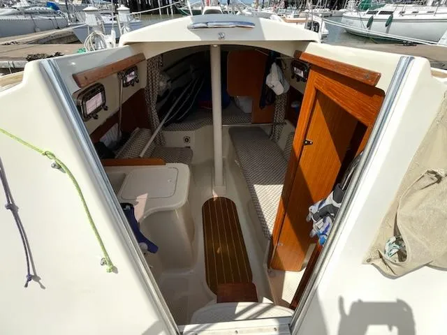Slide: The Image of Interior of a 2010 Seaward 26RK sailboat with wooden accents and cozy cabin space. - 13