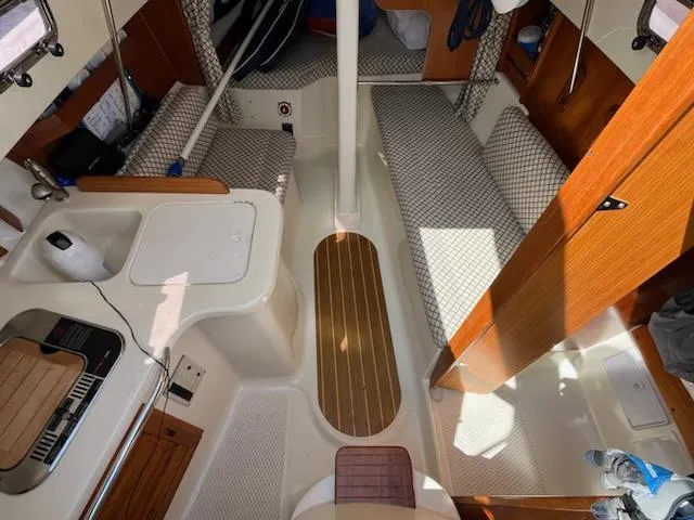 Slide: The Image of Interior of 2010 Seaward 26RK sailboat with compact kitchen and seating area. - 14
