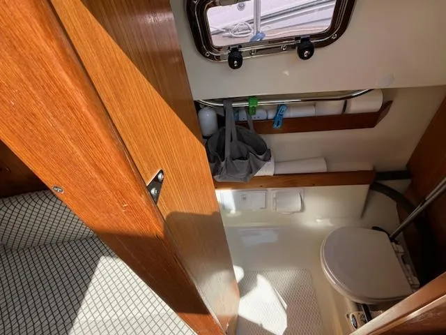 Slide: The Image of Seaward 26RK 2010 model boat bathroom with wooden door and small window. - 16
